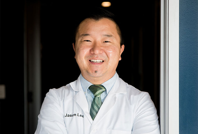 A woman sitting at a desk in an office, working on a computer.